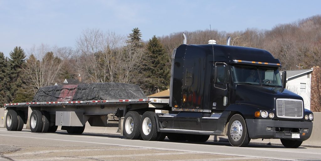 Flatbed truck loaded with freight on its way to Orlando, Florida