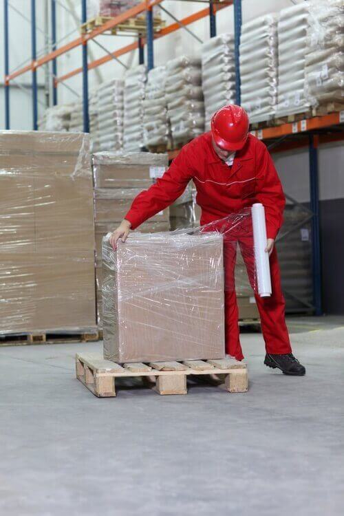 pallet warehouse box wrapping worker cellophane wrap shrink freight specialist working